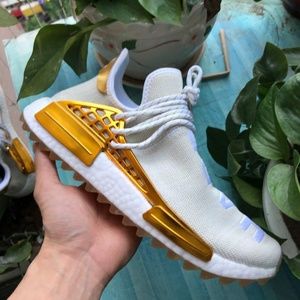 human race shoes gold